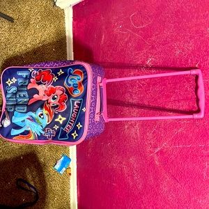 It is a purple an pink rainbow dash an pinky pie suit case